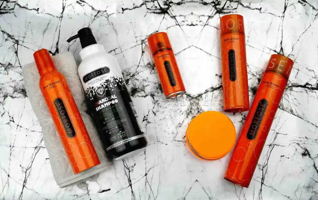 A collection of hair care products, including hair spray, which can be used as a golf grip solvent alternative for regripping clubs