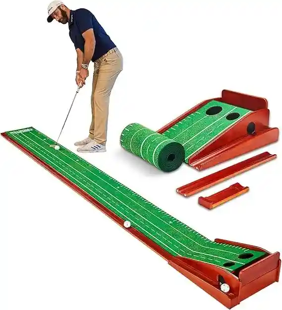 Alt text: A man is putting on a Perfect Practice putting mat. The mat is long and narrow, with a slight incline at the end leading to a hole. There is a ball return feature. Sources and related content